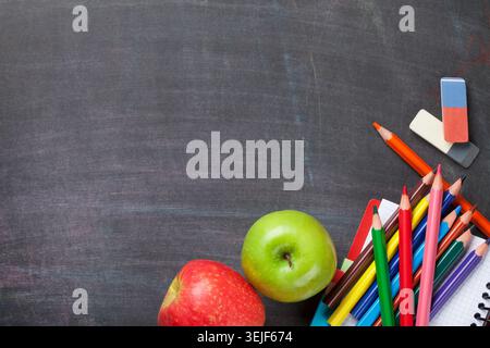 School supplies on blackboard background Stock Photo