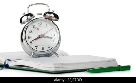 Alarm clock on notepad Stock Photo