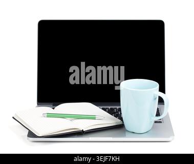 Tea cup and office supplies on laptop Stock Photo