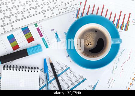 Blue coffee cup on financial papers Stock Photo