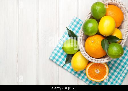 Citrus fruits in basket. Oranges, limes and lemons Stock Photo