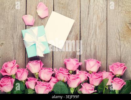 Valentines day greeting card, gift box and pink roses Stock Photo