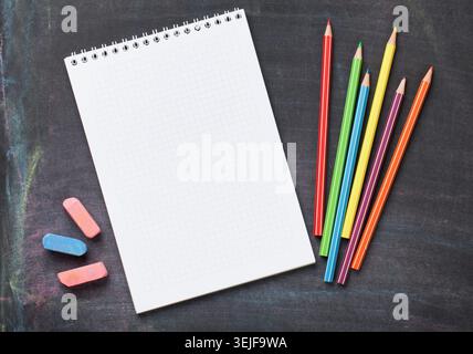 School supplies on blackboard background Stock Photo