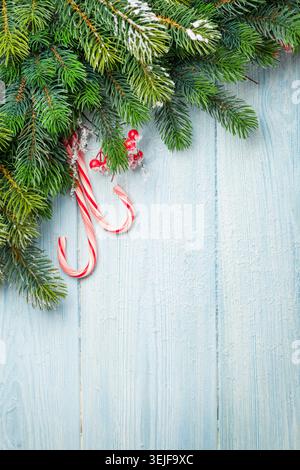 Candy cane and christmas tree on wooden table Stock Photo