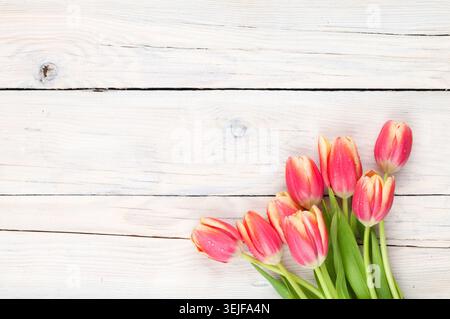 Colorful tulips on wooden table Stock Photo