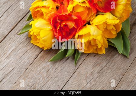 Colorful tulips over wooden table Stock Photo
