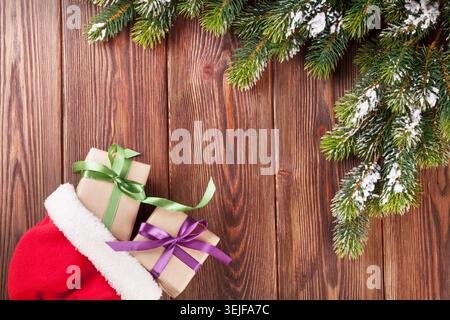 Christmas tree branch and santa hat with gift boxes Stock Photo