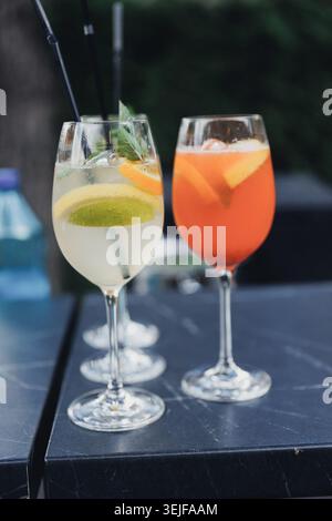 Two colorful cocktails sit on a dark table Stock Photo