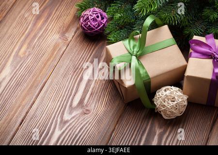 Christmas gift boxes and fir tree on table Stock Photo