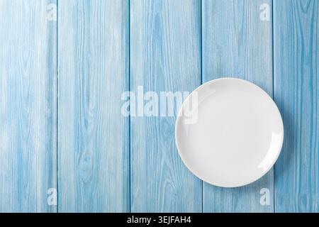 Empty plate on blue wooden background Stock Photo