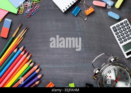 School supplies on blackboard background Stock Photo