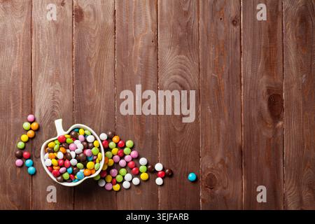Colorful candies over wood Stock Photo
