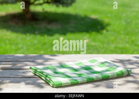 Empty wooden garden table with tablecloth Stock Photo