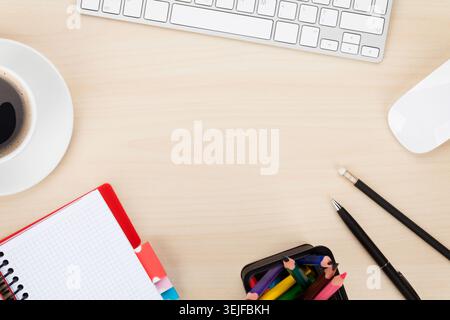 Office table with computer, supplies and coffee cup Stock Photo