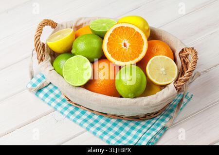 Citrus fruits in basket. Oranges, limes and lemons Stock Photo