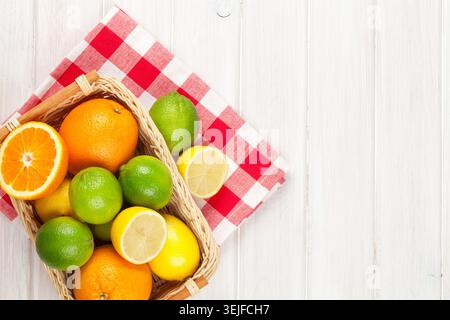 Citrus fruits in basket. Oranges, limes and lemons Stock Photo