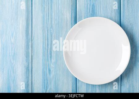 Empty plate on blue wooden background Stock Photo