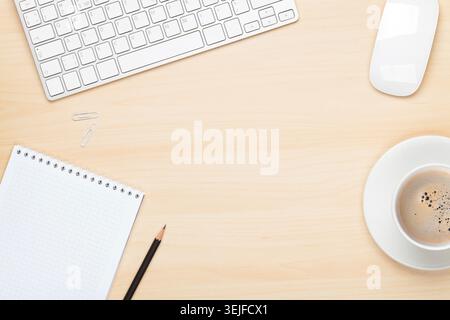 Office table with notepad, computer and coffee cup Stock Photo