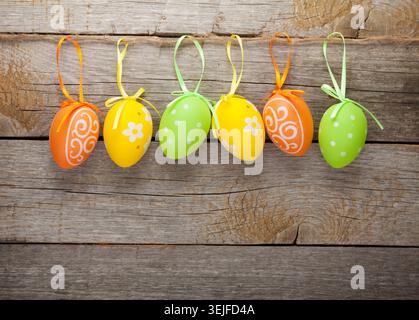 Easter eggs nest on plate over wooden background Stock Photo