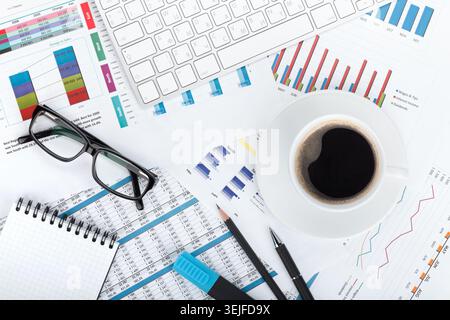 Coffee cup on financial papers Stock Photo