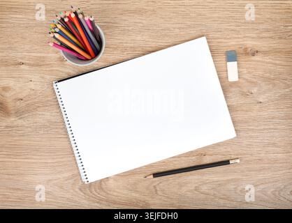 Blank paper and colorful pencils on the wooden table Stock Photo