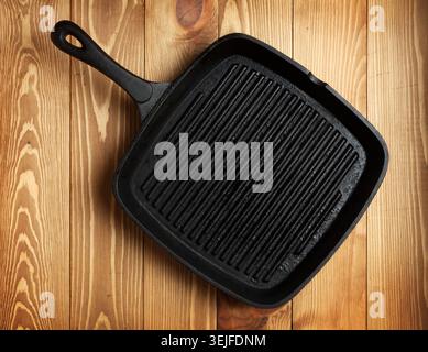 Frying pan on wooden table background Stock Photo