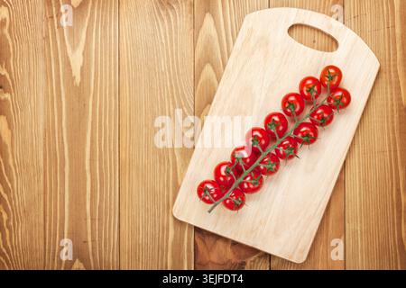 Cherry tomatoes on cutting board Stock Photo