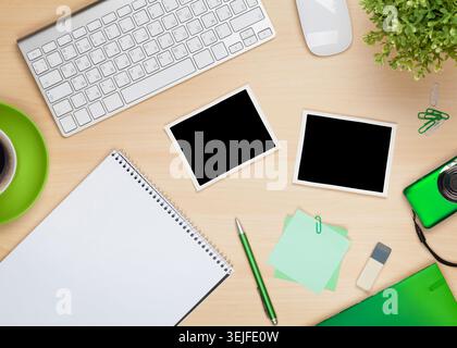Photo frames on office table with notepad, computer and camera Stock Photo