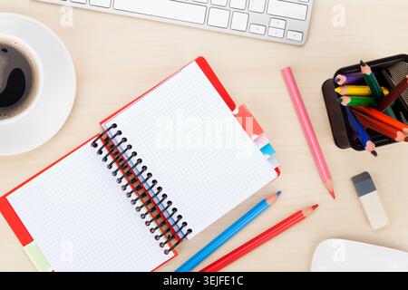 Office table with computer, supplies and coffee cup Stock Photo