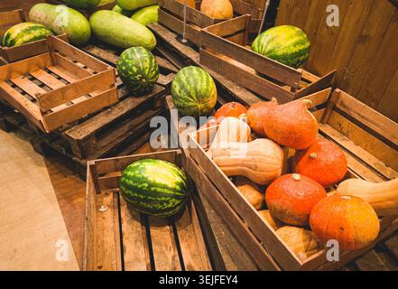 Watermelons and pumpkins, in a wooden box, on pallets, supermarket, lifestyle, no people, mobile photo, Stock Photo