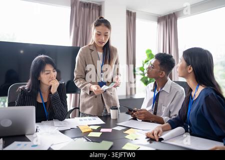 Business asian Multicultural businesspeople working project  working together in office conference ideas in startup at office Diversity leadership and Stock Photo
