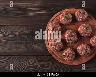 Raw meatballs, with micro greenery, on a cutting board, homemade, rustic, no people, Stock Photo