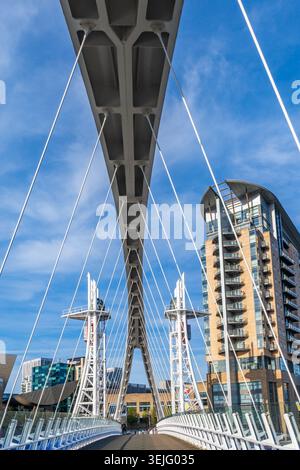 The Millennium footbridge, or the Lowry bridge,  a vertical lift bridge spanning the Manchester Ship Canal at Salford Quays, Manchester, England Stock Photo