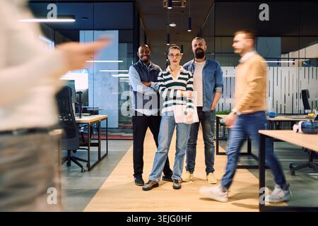 Group of confident business professionals posing together in a modern office environment, representing teamwork, diversity, leadership, and collaborat Stock Photo