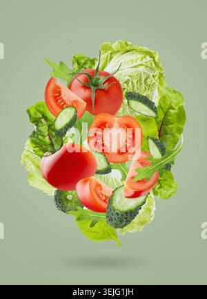 Fresh summer vegetable salad background. Salad ingredients -  chinese cabbage, tomatoes, cucumber, leafy greens fly as swirl on Stock Photo