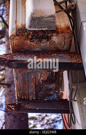An old and rusty air conditioner hanging on the hotel building, in the sunny outdoor, seaside resort, Stock Photo