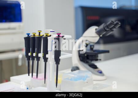 Laboratory scene with pipettes and microscope in a modern research facility Stock Photo