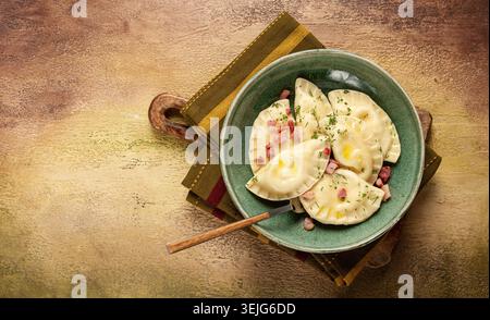 Dumplings, with fried prosciutto, a traditional dish of Polish cuisine, dumplings, top view, close-up, without people, Stock Photo