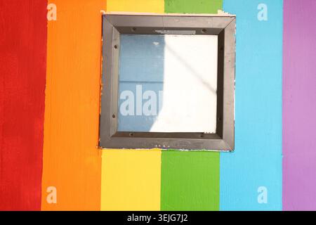 Square Glass Window on Colorful Rainbow Painted Wall with Copy Space Stock Photo