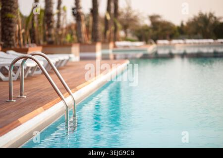Empty water pool with turquoise water. Early morning in hotel resort Stock Photo