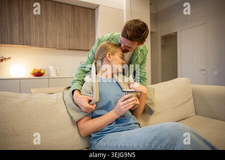 Cheerful smiling man and woman couple enjoying calm moments at home together, care in relationships. Stock Photo