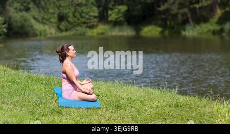 Woman wearing yoga clothes practicing yoga Stock Photo
