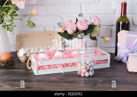 Eggs in the basket and flowers on kitchen counter decorated for Easter Stock Photo