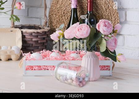 Eggs in the basket and flowers on kitchen counter decorated for Easter Stock Photo