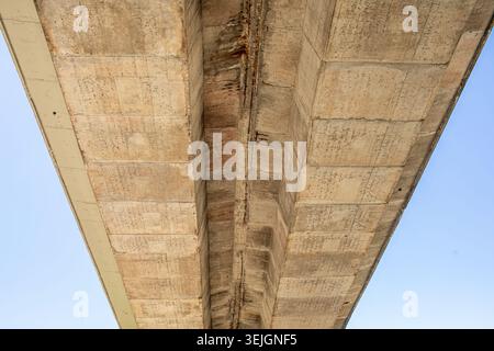 Highway bridge underside with concrete structure and geometric perspective Stock Photo