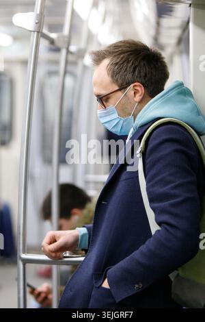 Man wearing protective mask in public transport Stock Photo