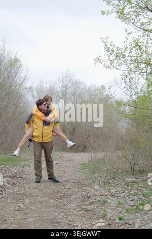 Young couple having fun and enjoying the beautiful nature in the forest Stock Photo
