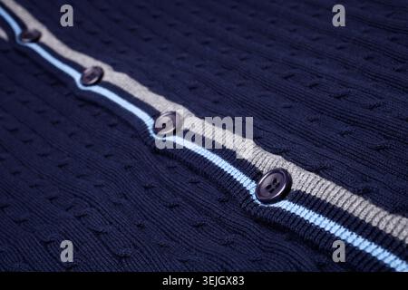 Closeup of buttons on blue cardigan, for backgrounds or textures Stock Photo