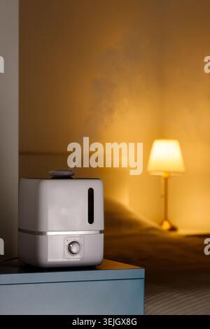 Aroma oil diffuser on the table, steam from humidifier Stock Photo