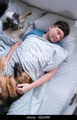 Man sleeping lying in the bed in the morning Stock Photo